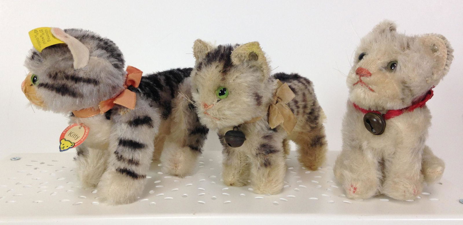 (3) VINTAGE STEIFF CATS. INCLUDES 4 1/2" LONG (NOT: (3) VINTAGE STEIFF CATS. INCLUDES 4 1/2" LONG (NOT INCLUDING TAIL) "KITTY". FULLY JOINTED MOHAIR WITH VELVET SNOUT AND FELT EARS, RETAINS ORIGINAL CHECK TAG, RIBBON AND EAR BUTTON/TAG; 4 1/2" LONG UNJ