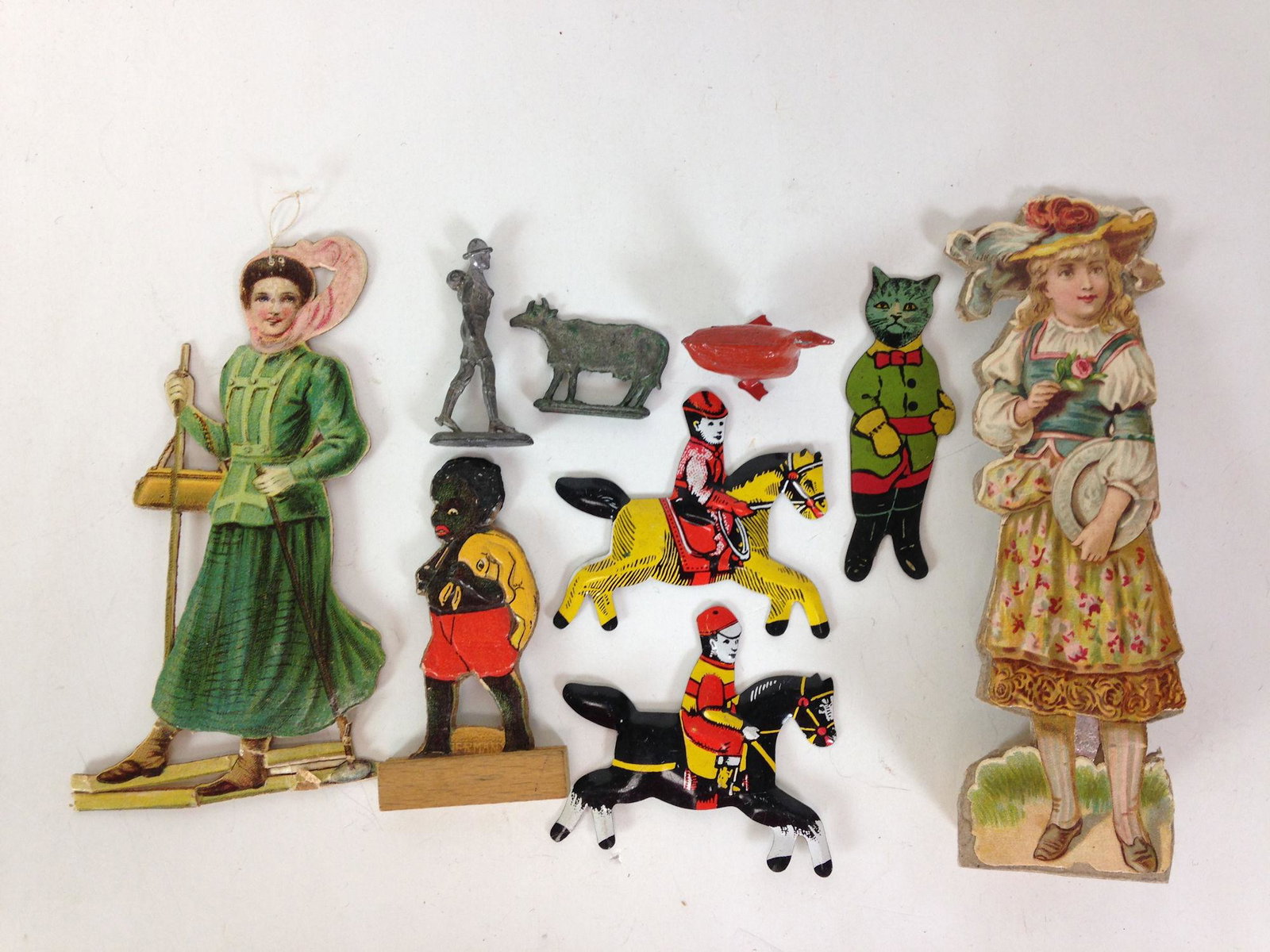 LOT MISCELLANEOUS MINIATURE FLAT TIN FIGURES. INCLUDES: LOT MISCELLANEOUS MINIATURE FLAT TIN FIGURES. INCLUDES PUSS 'N BOOTS.