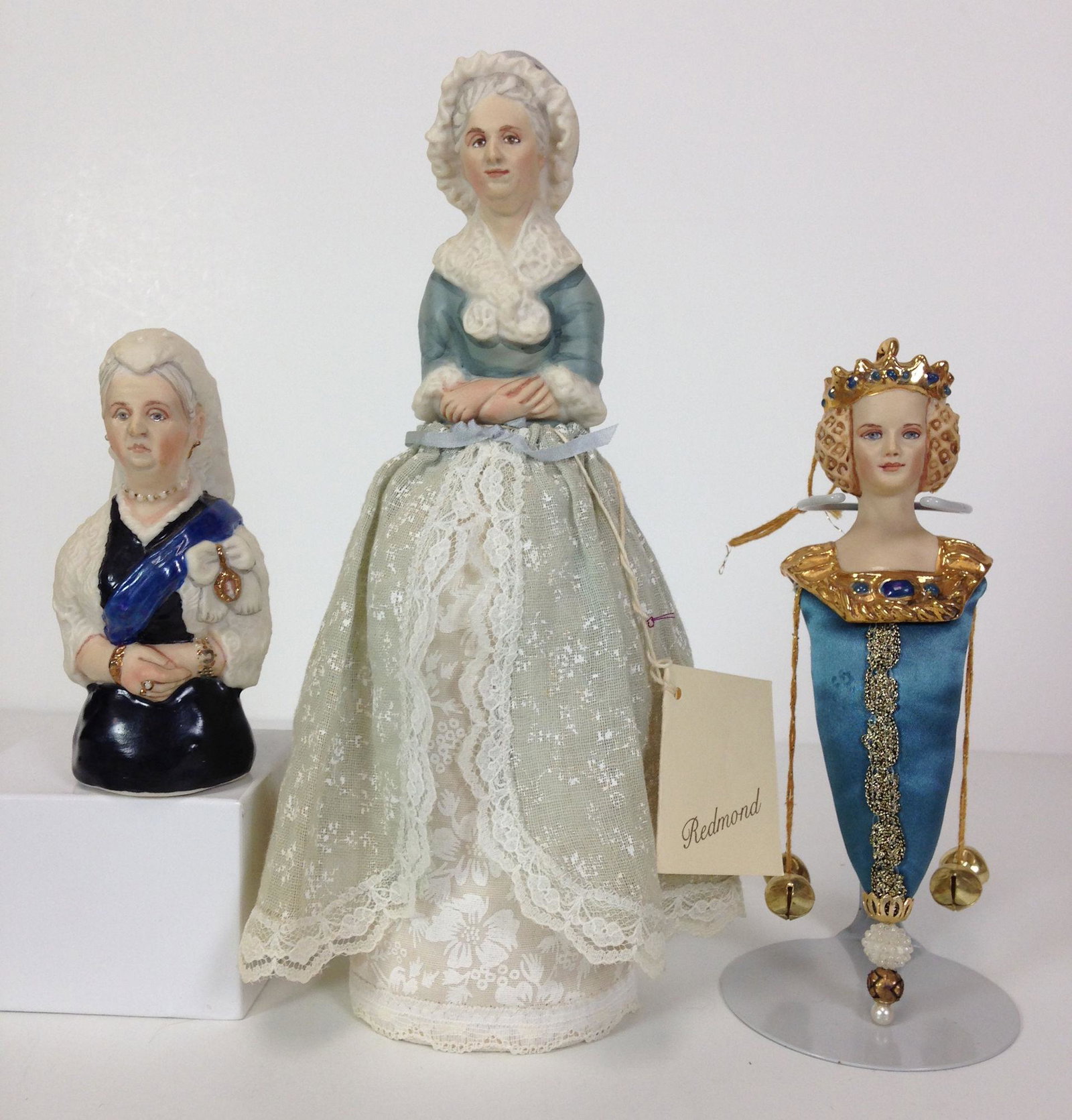 (3) KATHY REDMOND PORCELAIN HALF DOLLS INCLUDING 7": (3) KATHY REDMOND PORCELAIN HALF DOLLS INCLUDING 7" "ISABELLA DE BAVIERE" ORNAMENT, 9½" MARTHA WASHINGTON MADE INTO A PINCUSHION AND 4½" QUEEN VICTORIA. ALL ARE MARKED WITH KATHY REDMOND