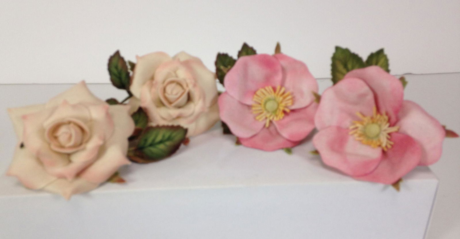 (2) PAIR R. JOHN WRIGHT ALL FELT NAPKIN RINGS MADE FOR: (2) PAIR R. JOHN WRIGHT ALL FELT NAPKIN RINGS MADE FOR UFDC CONVENTIONS INCLUDING (2) ROSES AND (2) APPLE BLOSSOMS.