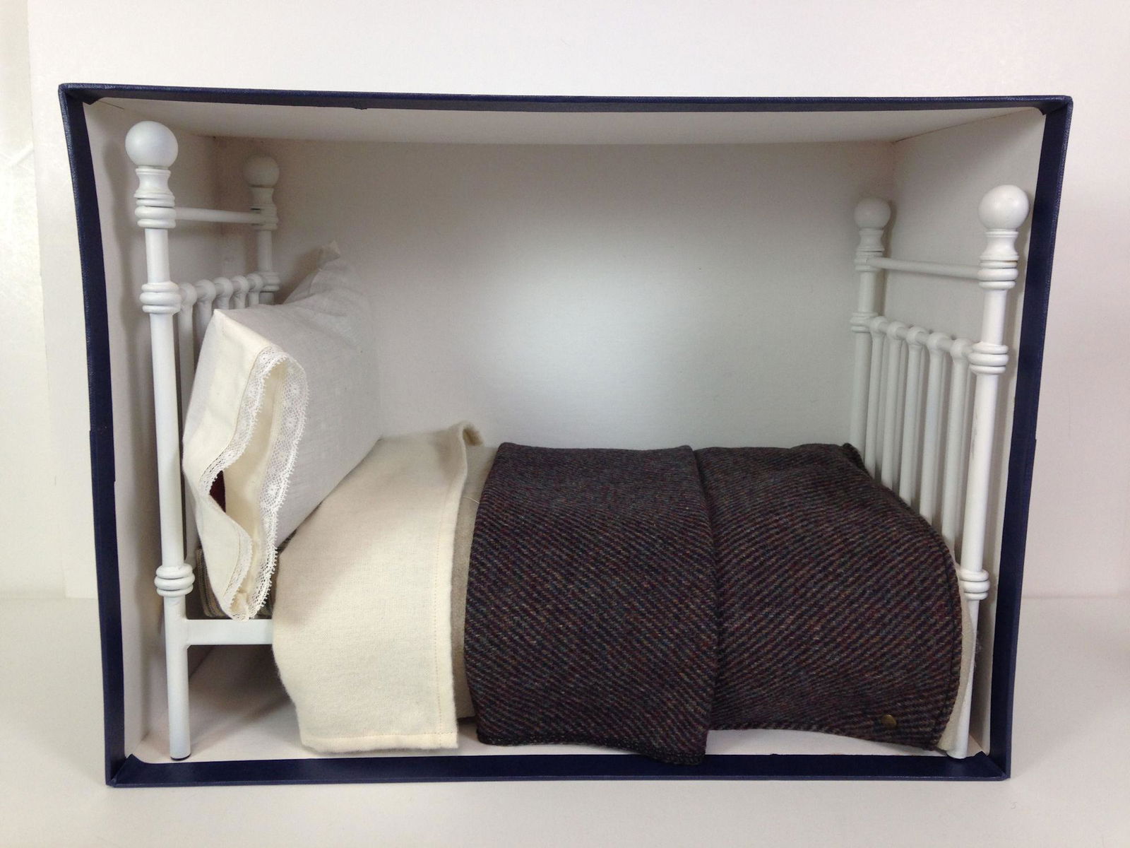 R. JOHN WRIGHT "BEAR'S BED". PAINTED IRON BED 8" WIDE X: R. JOHN WRIGHT "BEAR'S BED". PAINTED IRON BED 8" WIDE X 15" LONG X 12" HIGH, COMES WITH STRIPED TICKING MATTRESS, BEDDING AND PILLOW WITH LACE TRIMMED PILLOW CASE. LIMITED EDITION #11/500, IN ORIGINAL