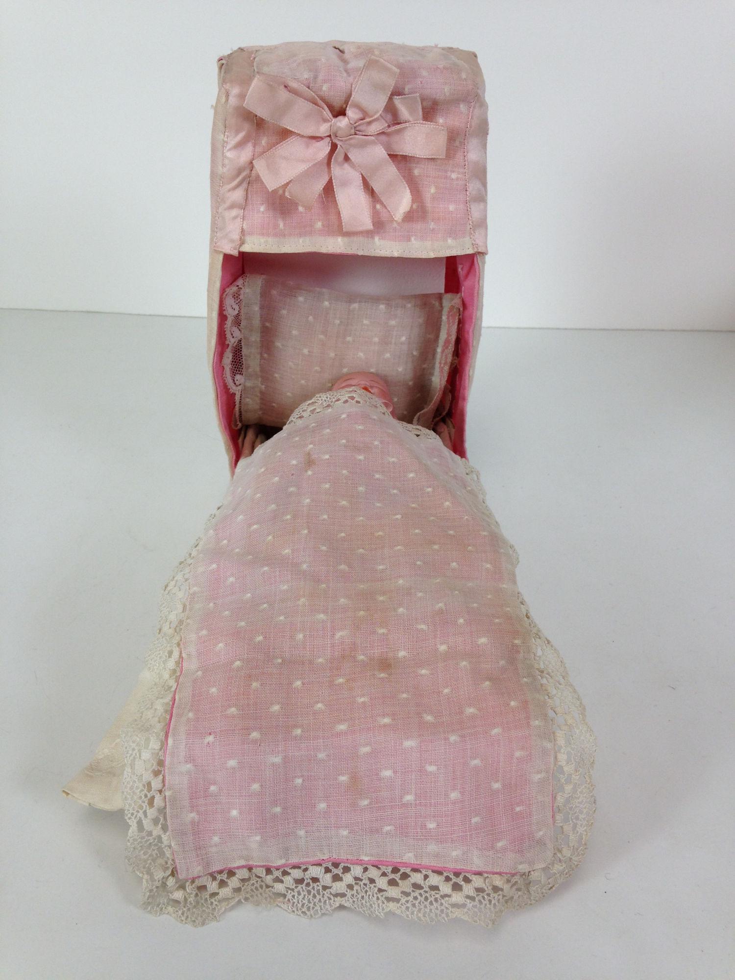 6" GEBRUDER HEUBACH CHARACTER BABY. SOLID DOME SOCKET: 6" GEBRUDER HEUBACH CHARACTER BABY. SOLID DOME SOCKET HEAD WITH MOLDED AND PAINTED HAIR AND FACIAL FEATURES, ON CRUDE FIVE-PIECE BABY BODY. COMES WITH HOMEMADE BED MADE FROM A CANDY BOX. HEAD MARKED A