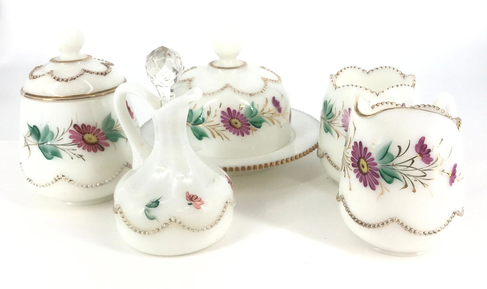 HEISEY 5 PIECE OPAL BEAD SWAG TABLE SET ALL W/ROSE BUD: HEISEY 5 PIECE OPAL BEAD SWAG TABLE SET ALL W/ROSE BUD DECORATION, COVERED BUTTER, COVERED SUGAR, CREAMER AND SPOONER, OPAL CRUET W/FACETED STOPPER. WEAR TO DECORATION.