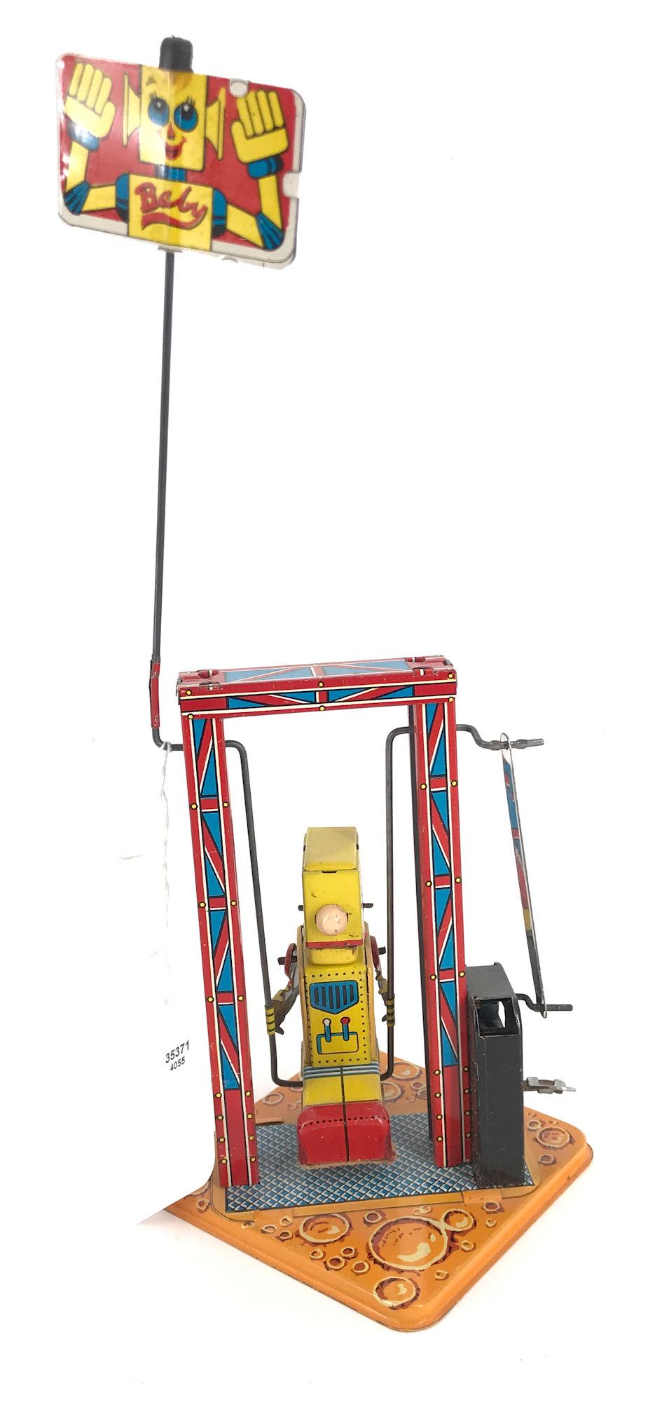 TIN WINDUP TOY-ROBOT ON SWING (MADE IN JAPAN) WORKED AT: TIN WINDUP TOY-ROBOT ON SWING (MADE IN JAPAN) WORKED AT TIME OF LISTING 12" TALL