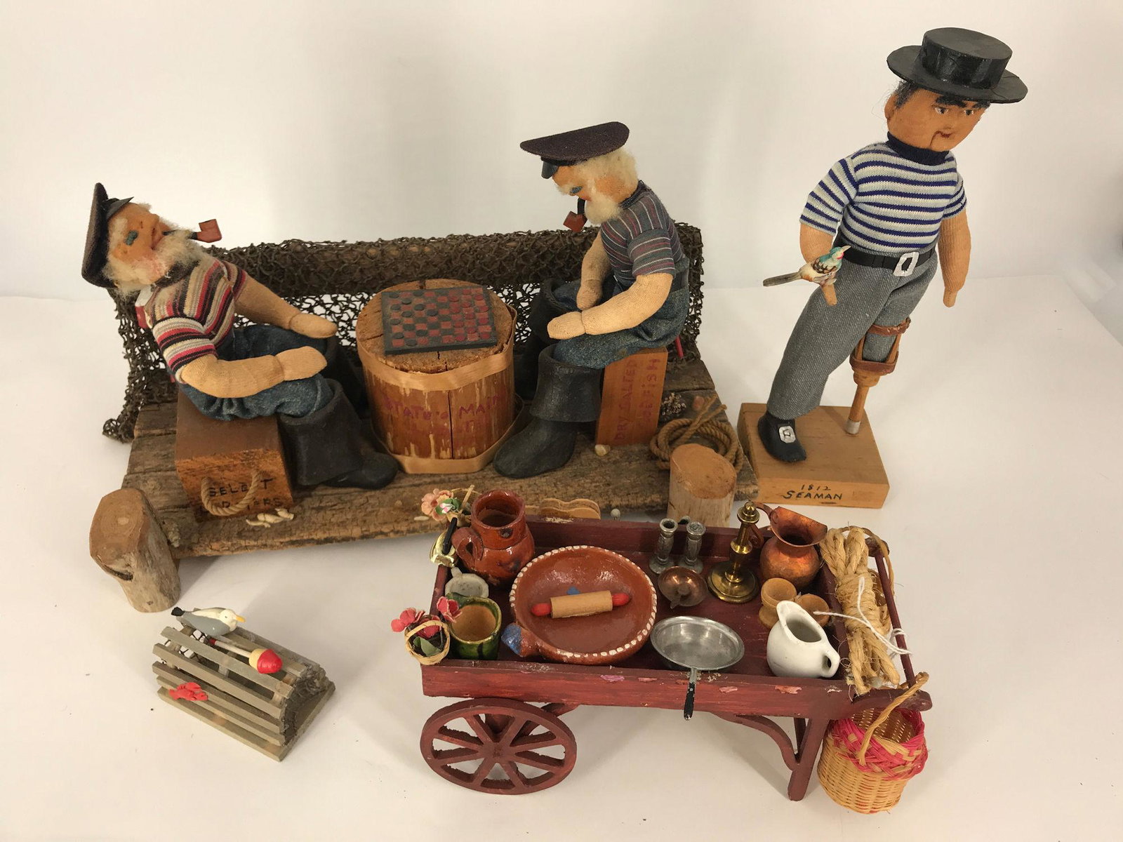 BOX LOT INCLUDING WOOD AND SOFT SCULPTURE SCENE OF: BOX LOT INCLUDING WOOD AND SOFT SCULPTURE SCENE OF FISHERMEN PLAYING CHECKERS, AND FISHERMAN WITH PEG LEG