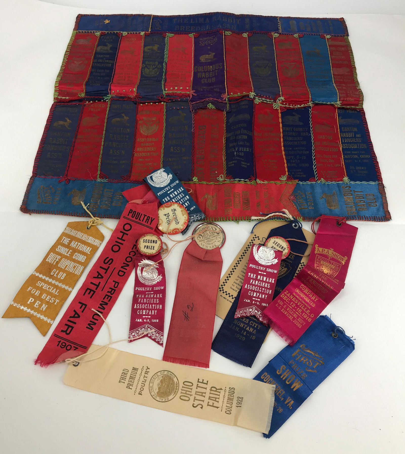 BOX LOT AWARD RIBBONS INCLUDING POULTRY AND A PIANO: BOX LOT AWARD RIBBONS INCLUDING POULTRY AND A PIANO SHAWL MADE FROM 1920S RABBIT AWARD RIBBONS.