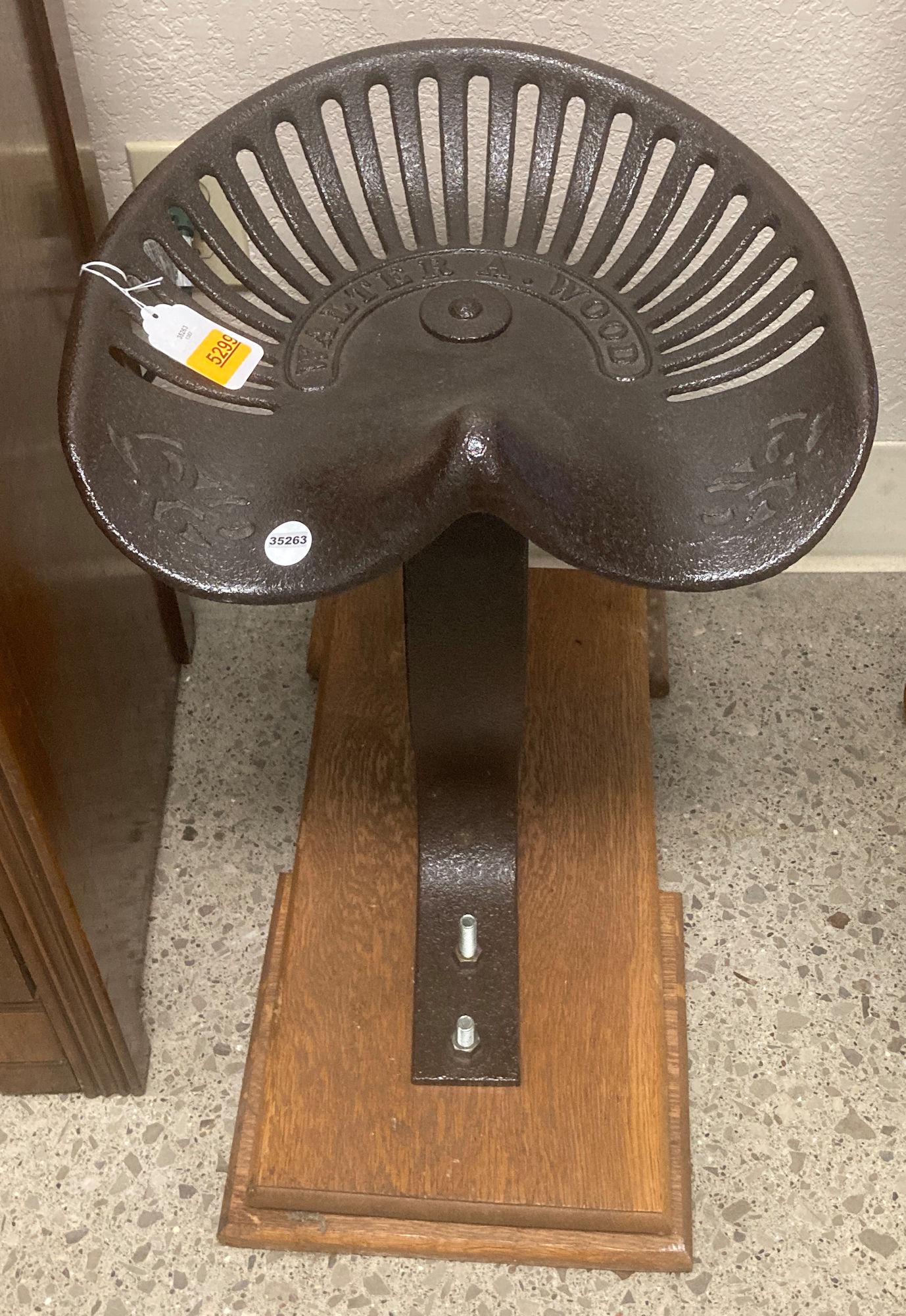 IRON TRACTOR SEAT MOUNTED ON WOODEN BASE 21"TALL: IRON TRACTOR SEAT MOUNTED ON WOODEN BASE 21"TALL