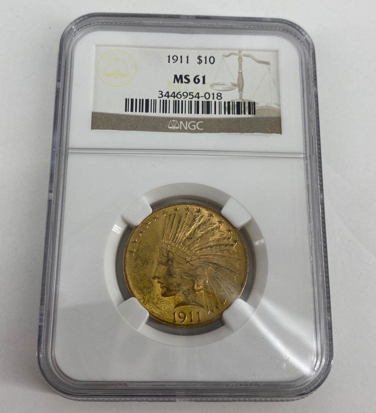 1911 U.S. $10.00 INDIAN HEAD GOLD EAGLE: 1911 U.S. $10.00 INDIAN HEAD GOLD EAGLE ~ NO MINT MARK, IN SLAB, NGC GRADED MS61, NUMBERED 3446954-018, 90% FINE GOLD, APPROX. 16.72 GRAMS TW. DESIGNED BY AUGUSTUS SAINT GAUDENS.