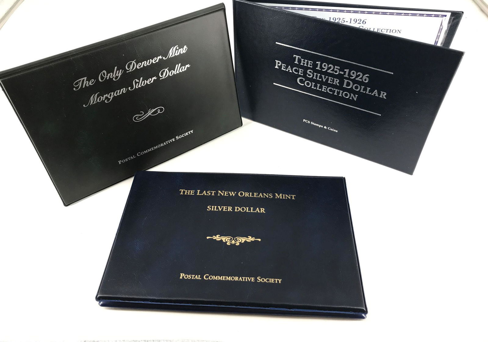 LOT OF FOUR U.S. SILVER DOLLAR COINS IN FOLIOS FROM PCS (1 of 4)