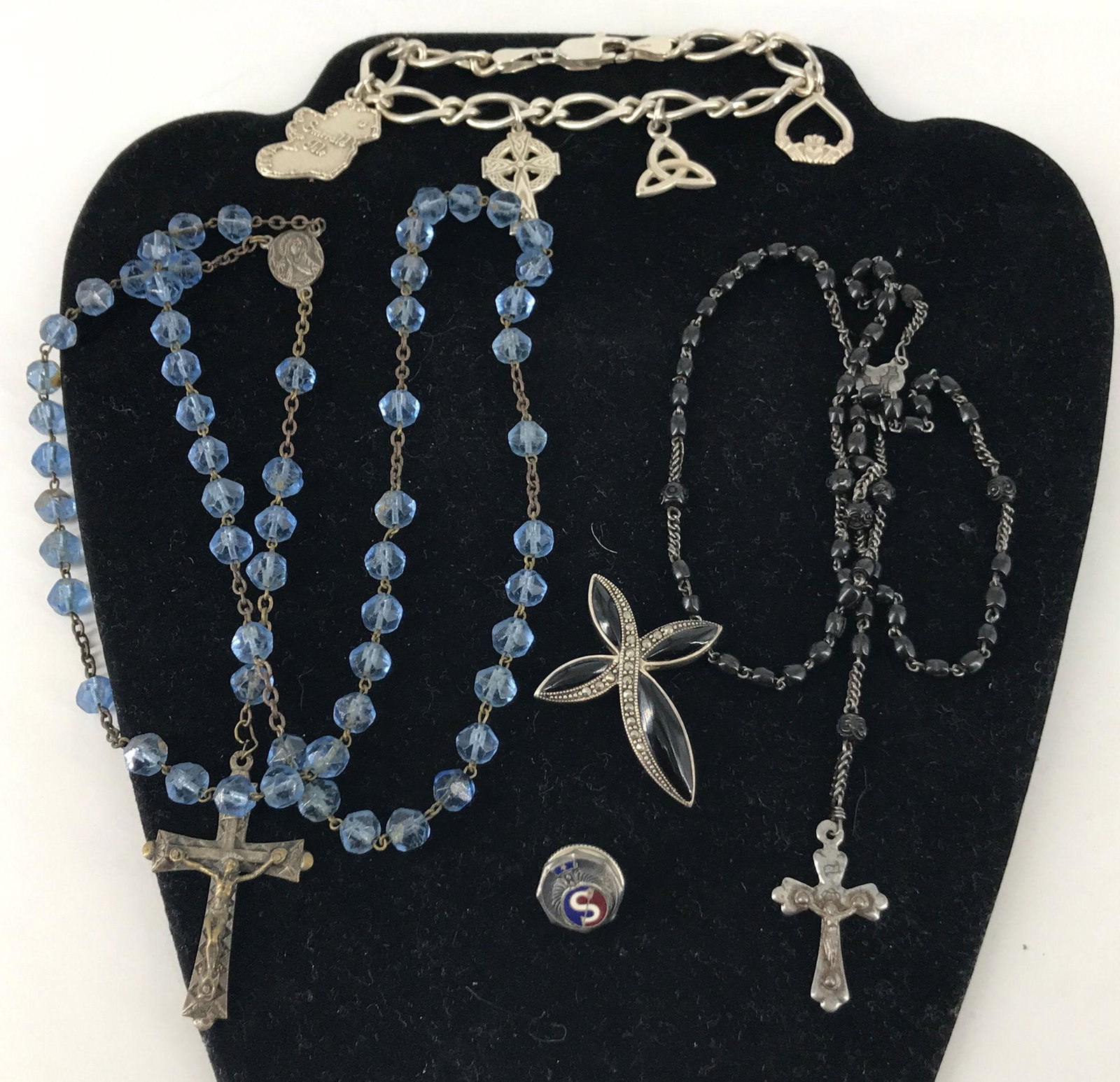 RELIGIOUS JEWELRY: RELIGIOUS JEWELRY ~ STERLING CHARM BRACELET (0.66 TROY OUNCES TW.). 24" BLUE GLASS BEAD ROSARY WITH CORPUS CROSS. 1.5" STERLING, ONYX AND MARCASITE CROSS PENDANT. 17" BLACK BEAD ROSARY WITH FLORETS AN