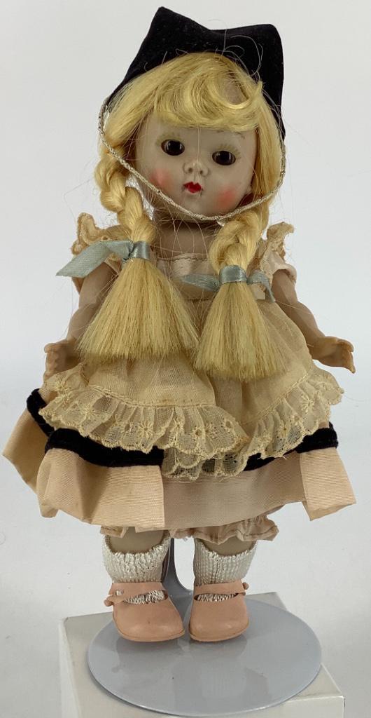 7 1/2" VOGUE HARD PLASTIC SL GINNY. BLONDE BRAIDED WIG,: 7 1/2" VOGUE HARD PLASTIC SL GINNY. BLONDE BRAIDED WIG, SLEEP EYES, PAINTED LASHES, DRESSED IN TAGGED VOGUE "ALICE IN WONDERLAND" TAFFETA DRESS WITH BLACK TRIM, MATCHING UNDERPANTS, BLACK VELVET HAT, 