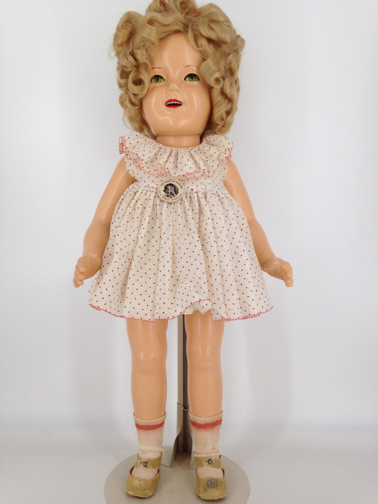 25" IDEAL ALL COMPOSITION FLIRTY-EYE SHIRLEY TEMPLE: 25" IDEAL ALL COMPOSITION FLIRTY-EYE SHIRLEY TEMPLE DOLL; MARKED AS SHOWN. MOHAIR WIG, BLUE SLEEP EYES AND OPEN MOUTH WITH TEETH. ON FIVE-PIECE COMPOSITION BODY. WEARS TAGGED RED POLKA-DOT "CURLY TOP"