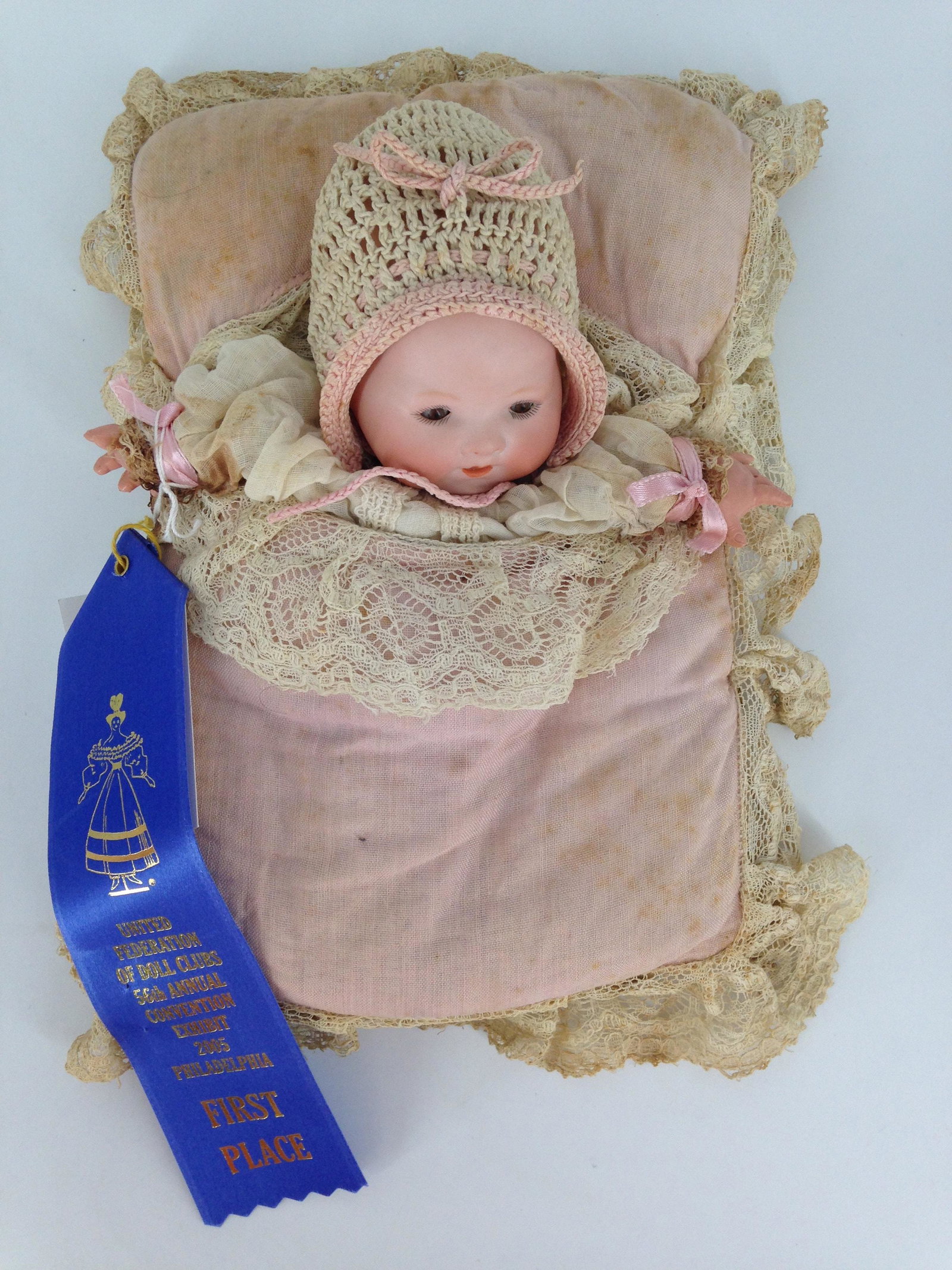 ARMAND MARSEILLE 351 BISQUE FLANGE HEAD PUPPET. HEAD: ARMAND MARSEILLE 351 BISQUE FLANGE HEAD PUPPET. HEAD CIRC. 9", PAINTED HAIR, BROWN GLASS SLEEP EYES, OPEN MOUTH WITH TWO LOWER TEETH, CELLULOID HANDS, MADE ONTO PILLOW WITH OPENING UNDERNEATH FOR YOUR