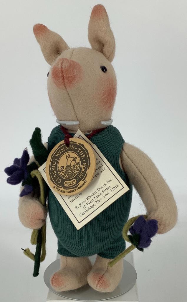 8" (to top of ears) R. John Wright "Piglet with: 8" (to top of ears) R. John Wright "Piglet with Violets". All felt, molded center seam head, applied ears, bead eyes, on five-piece body with disk jointed arms and legs. Piglet is dressed in green jer