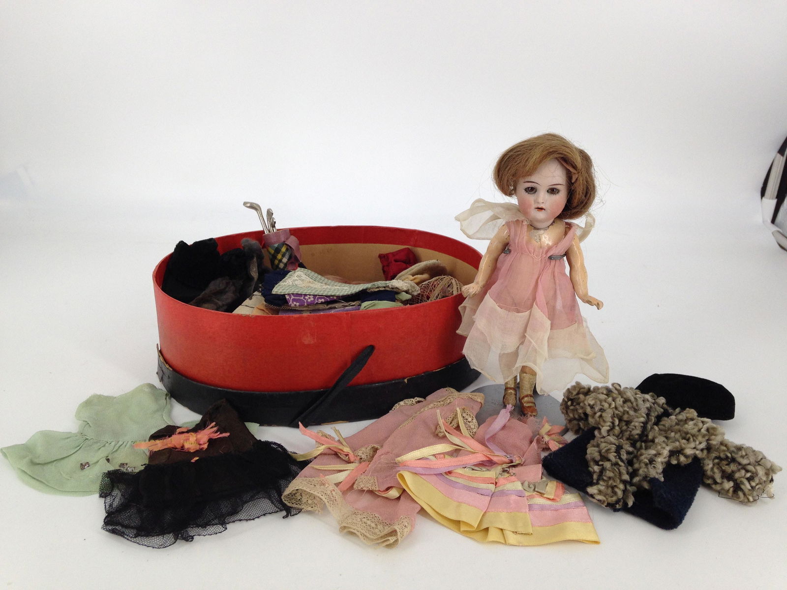 7Â¼" K&R BISQUE SOCKET HEAD CHILD. HUMAN HAIR WIG,: 7 1/4" K&R BISQUE SOCKET HEAD CHILD. HUMAN HAIR WIG, GLASS SLEEP EYES AND OPEN MOUTH WITH TEETH. ON FIVE-PIECE COMPOSITION BODY WITH MOLDED AND PAINTED STOCKINGS AND TWO-STRAP SHOES. COMES WITH OV