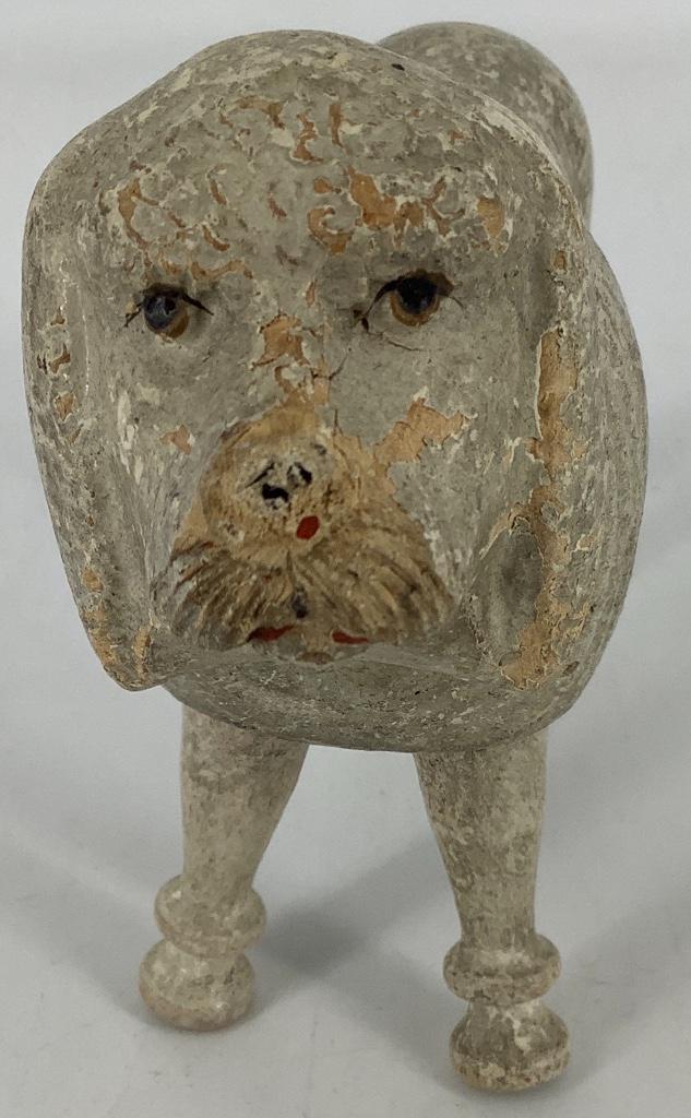 Schoenhut Poodle. 7 1/2" long, all wood with painted: Schoenhut Poodle. 7 1/2" long, all wood with painted eyes, original rope tail. Stringing is tight and the poodle holds a pose, overall wear, paint flaking on head.