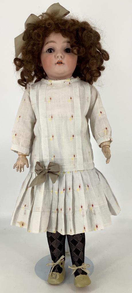 22" Kestner 143 bisque socket head character child.: 22" Kestner 143 bisque socket head character child. Replaced mohair wig, glass sleep eyes, open mouth with teeth, on jointed composition body. Nicely redressed. Bisque is good with no apparent damage,