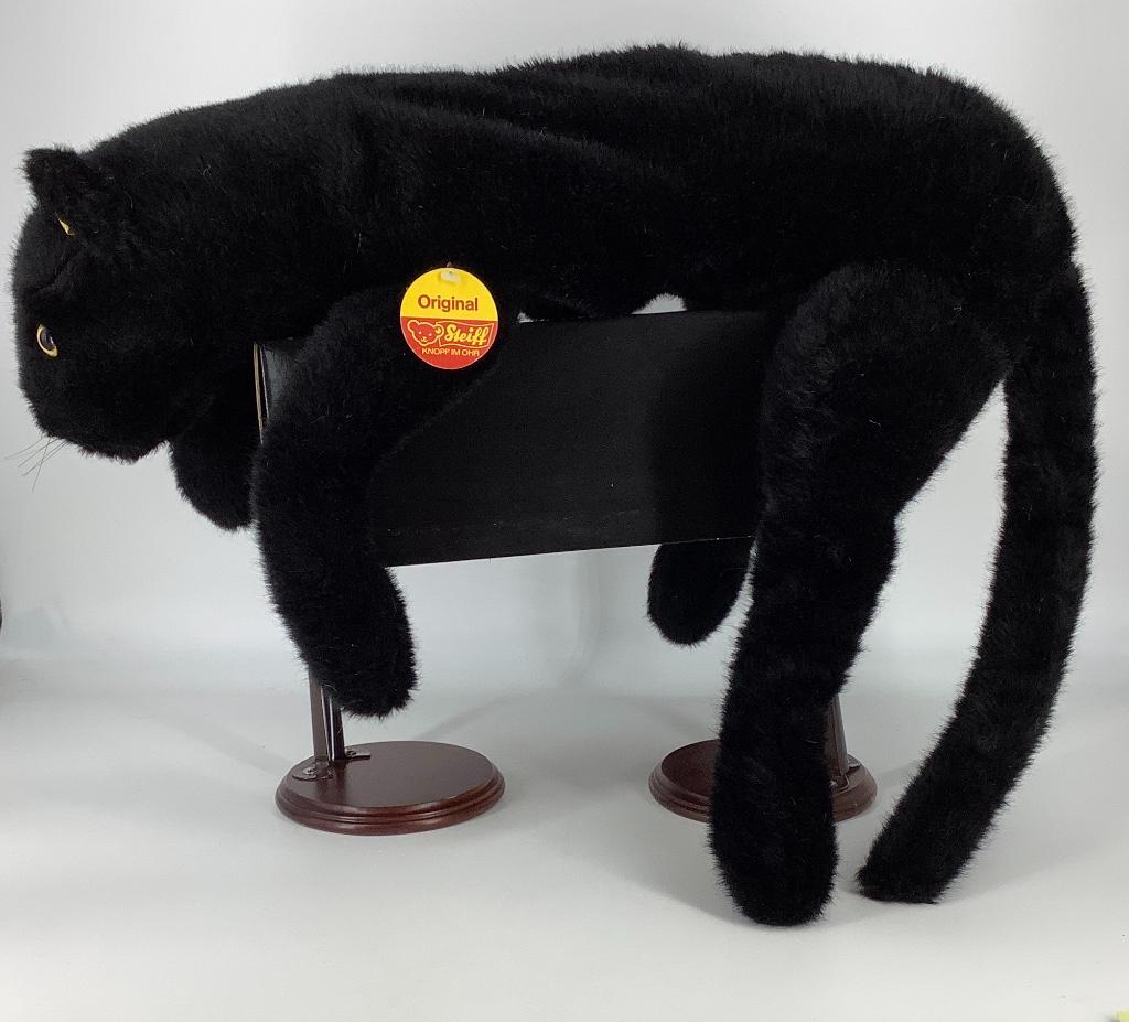 Steiff black panther. 23" long from nose to end of body: Steiff black panther. 23" long from nose to end of body (excluding tail), all plush and unjointed. Panther has plastic eyes, stitched nose and mouth, whiskers. Small mark on left eye. No odors.