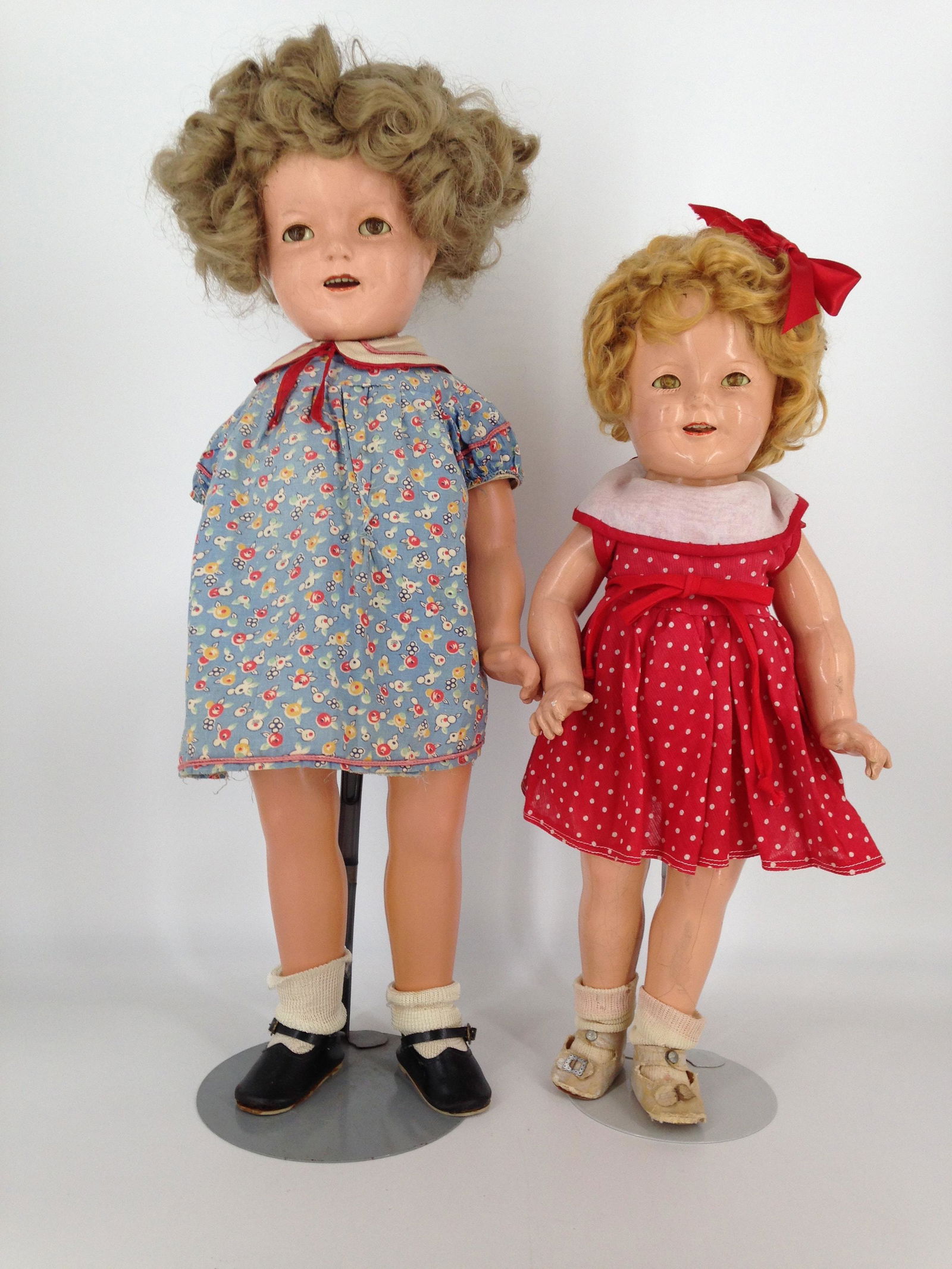 (2) VINTAGE COMPOSITION IDEAL SHIRLEY TEMPLE DOLLS; 18": (2) VINTAGE COMPOSITION IDEAL SHIRLEY TEMPLE DOLLS; 18" AND 22". 18" HAS MOHAIR WIG AND 22" HAS REPLACED WIG. BOTH HAVE SLEEP EYES, OPEN MOUTHS WITH TEETH AND FIVE-PIECE COMPOSITION BODIES REDRESSED I