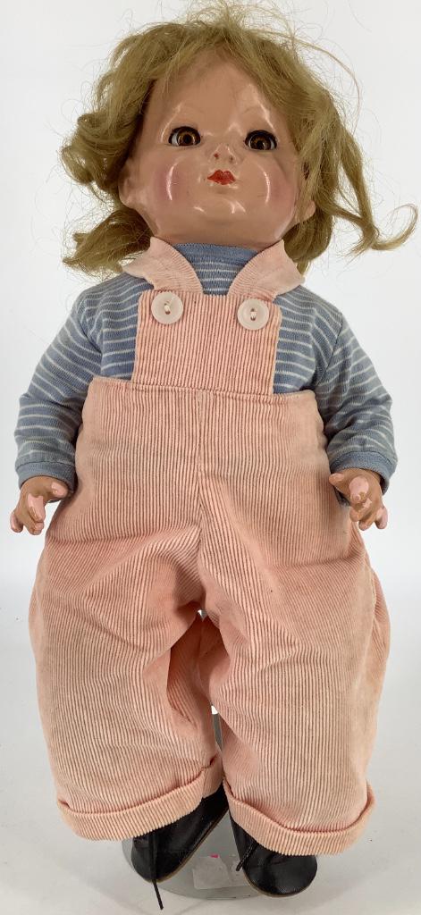 16" Effanbee composition flange head baby. Marked: 16" Effanbee composition flange head baby. Marked "Effanbee Made in U.S.A", human hair wig over molded hair, flirty sleep eyes with eyelashes, closed mouth, on cloth body with composition arms and low
