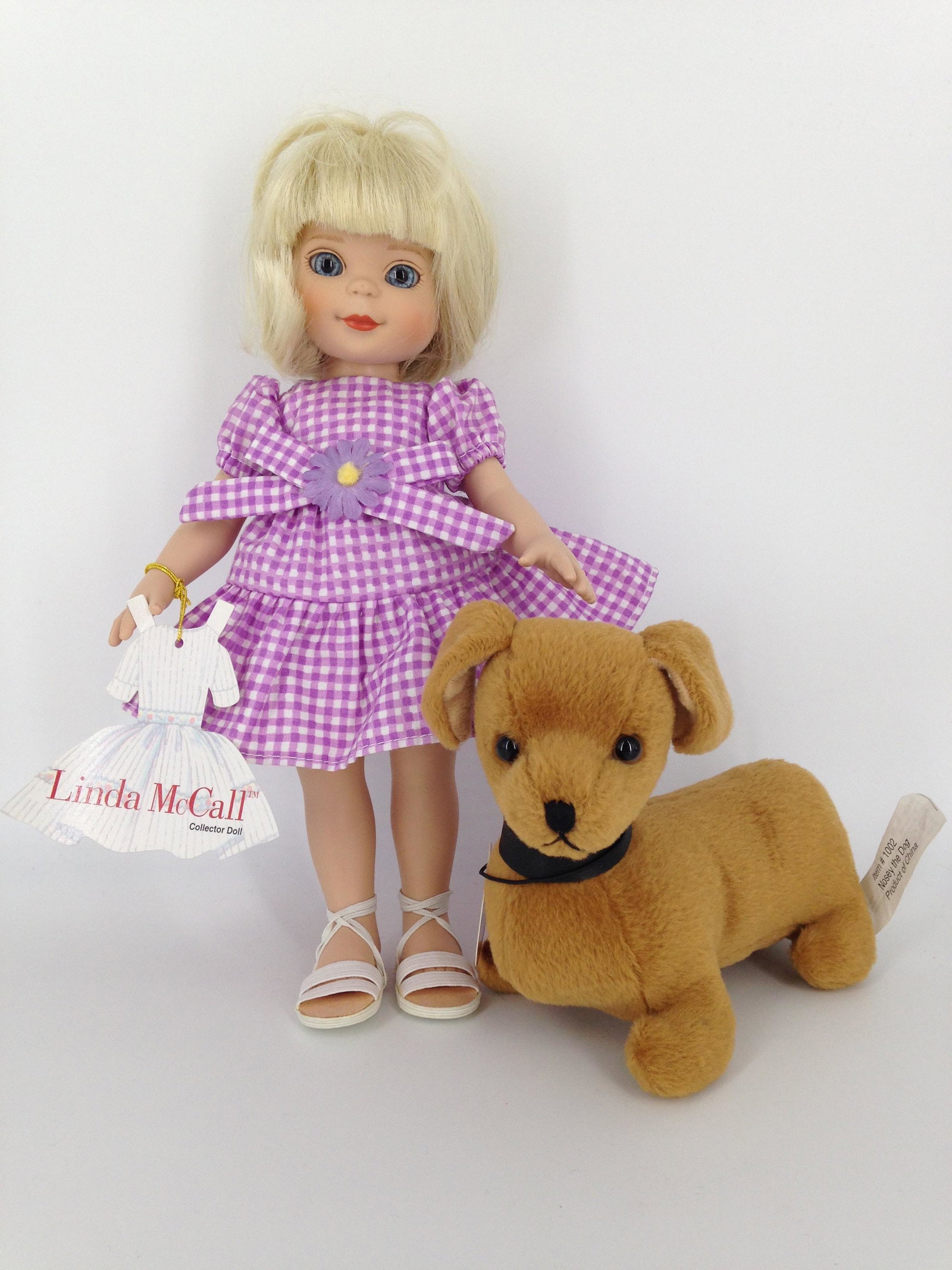 10Â½" ROBERT TONNER "LINDA MCCALL" DRESSED IN ORIGINAL: 10 1/2" ROBERT TONNER "LINDA MCCALL" DRESSED IN ORIGINAL SUNDRESS AND SANDALS AND COMES IN ORIGINAL BOX WITH (5) EXTRA OUTFITS AND DOG "NOSEY". OUTFITS INCLUDE PAJAMAS WITH TEDDY, CHRISTMAS DRESS WITH