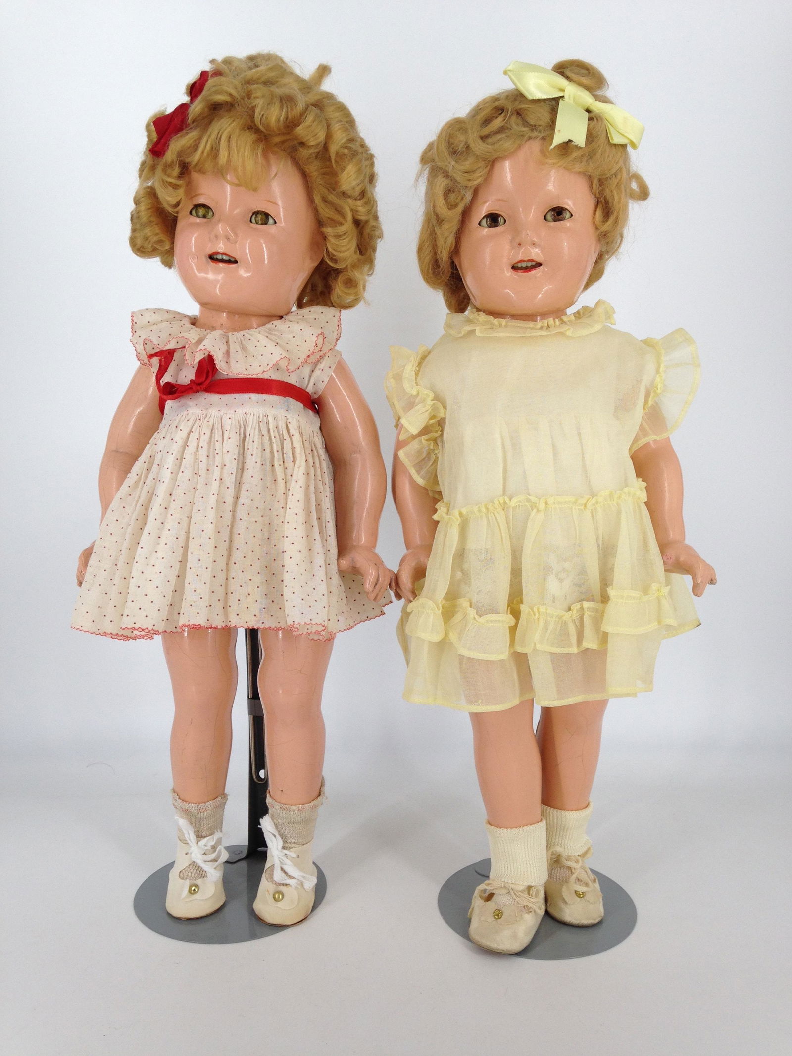 (2) 18" IDEAL COMPOSITION SHIRLEY TEMPLE DOLLS. MARKED: (2) 18" IDEAL COMPOSITION SHIRLEY TEMPLE DOLLS. MARKED "SHIRLEY TEMPLE 18", MOHAIR WIGS, SLEEP EYES, OPEN MOUTHS WITH TEETH, ON FIVE-PIECE COMPOSITION BODIES. ONE WEARS TAGGED "CURLY TOP" DRESS, ONE-P