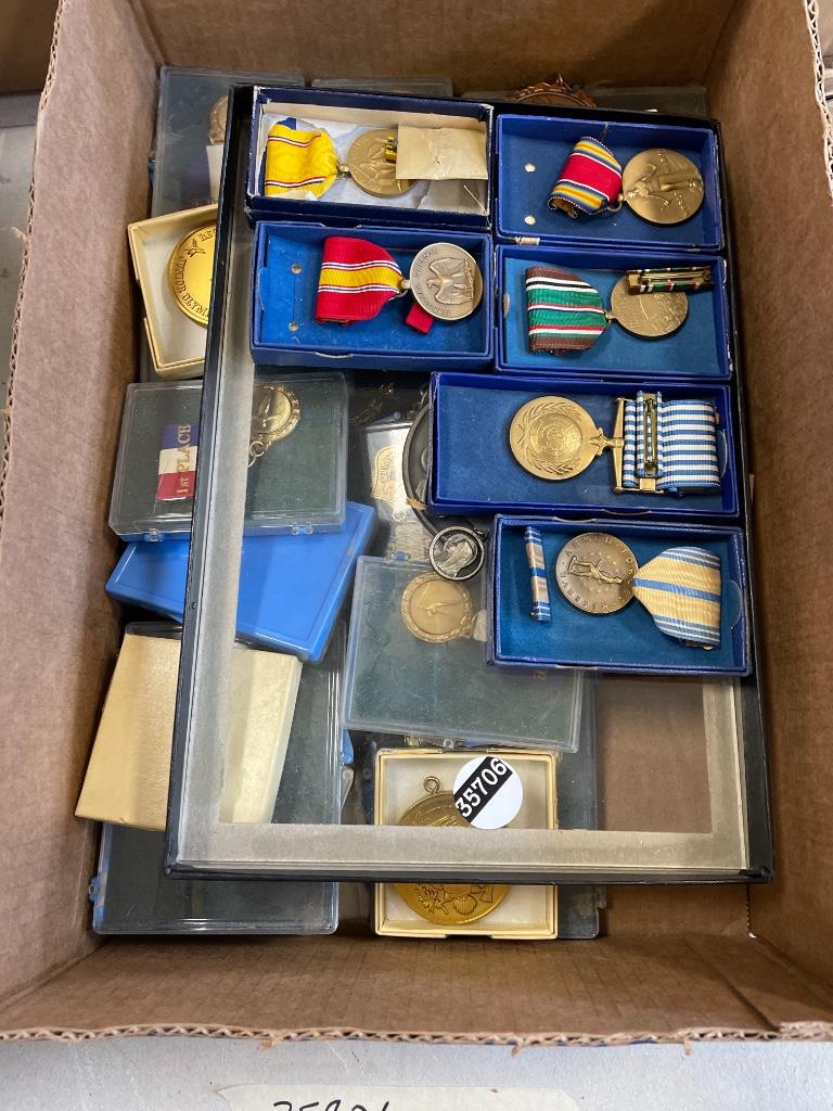Box lot of old military metals and Junior Olympics: Box lot of old military metals and Junior Olympics metals.