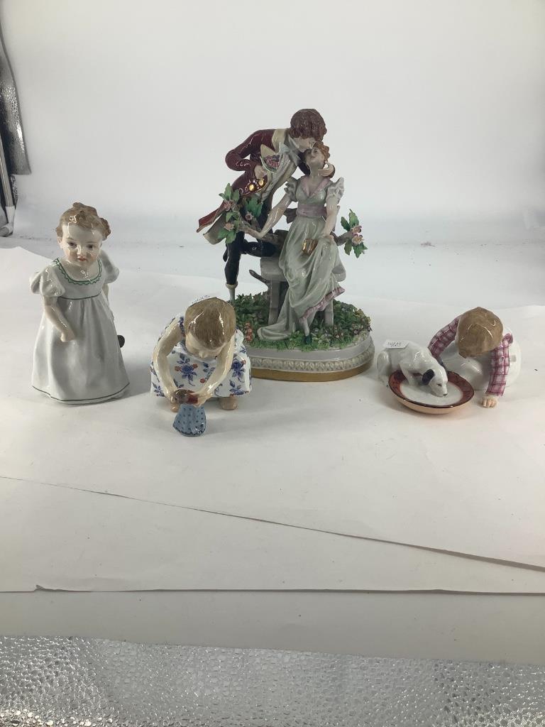 Meissen and china pieces including 2 small children: Meissen and china pieces including 2 small children holding dolls,small child with puppy and water dish and man and woman on parry bench in a garden setting, some damage done to finger tips and a rose