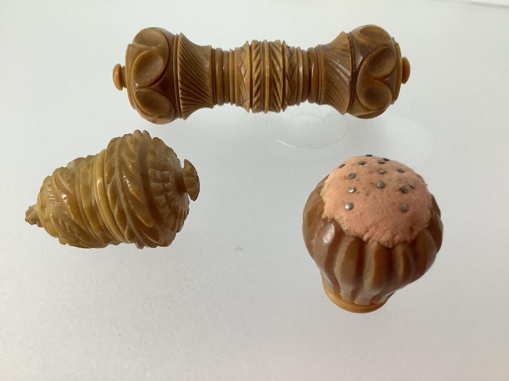 Three pieces vegetable ivory sewing tools including a: Three pieces vegetable ivory sewing tools including a pincushion, a thimble case and a needle case.
