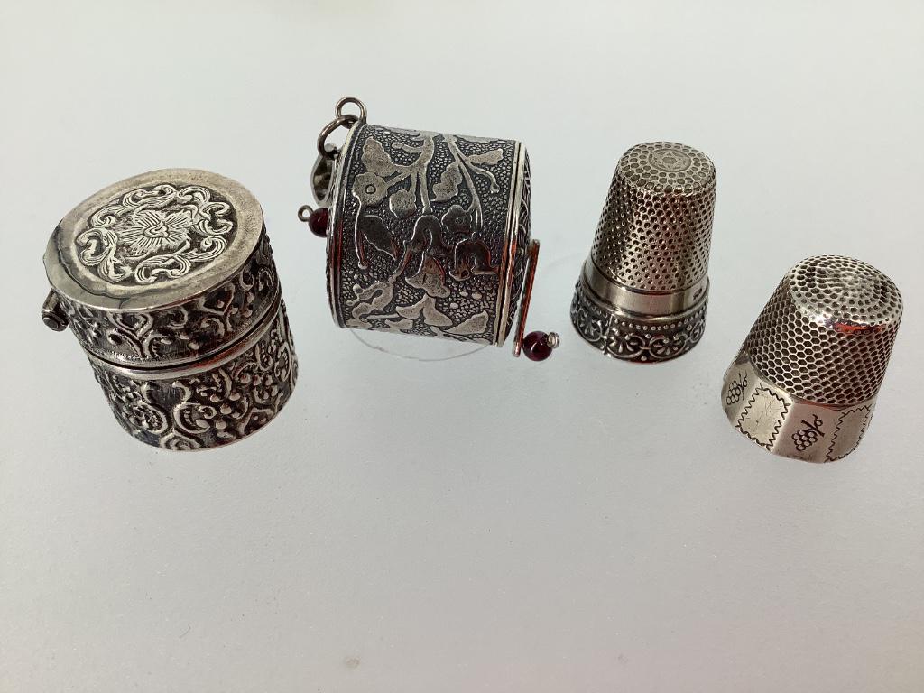 Sterling silver sewing items including two thimbles,: Sterling silver sewing items including two thimbles, tape measure and thimble box.