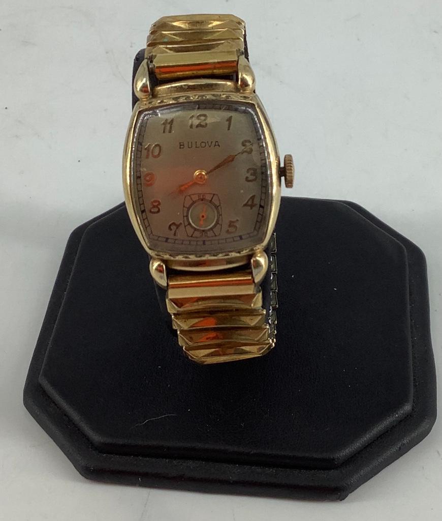 Vintage Bulova Wrist Watch: Vintage Bulova Wrist Watch Gold tone polished band, gold tone hour indicators and hands, brushed off white face, case #6351647, 17 jewel movement, crystal slightly scratched