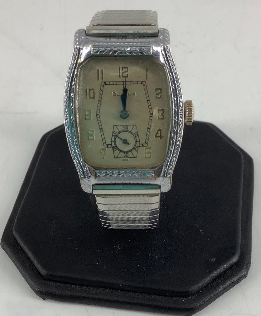 Bulova Wrist Watch: Bulova Wrist Watch Winds, sets and ticks at time of listing. Off-white face with gold tone numeric indicators on Speidel stretch band (face measures 24.5mm x 21.75mm in size). 14kt white gold-filled c