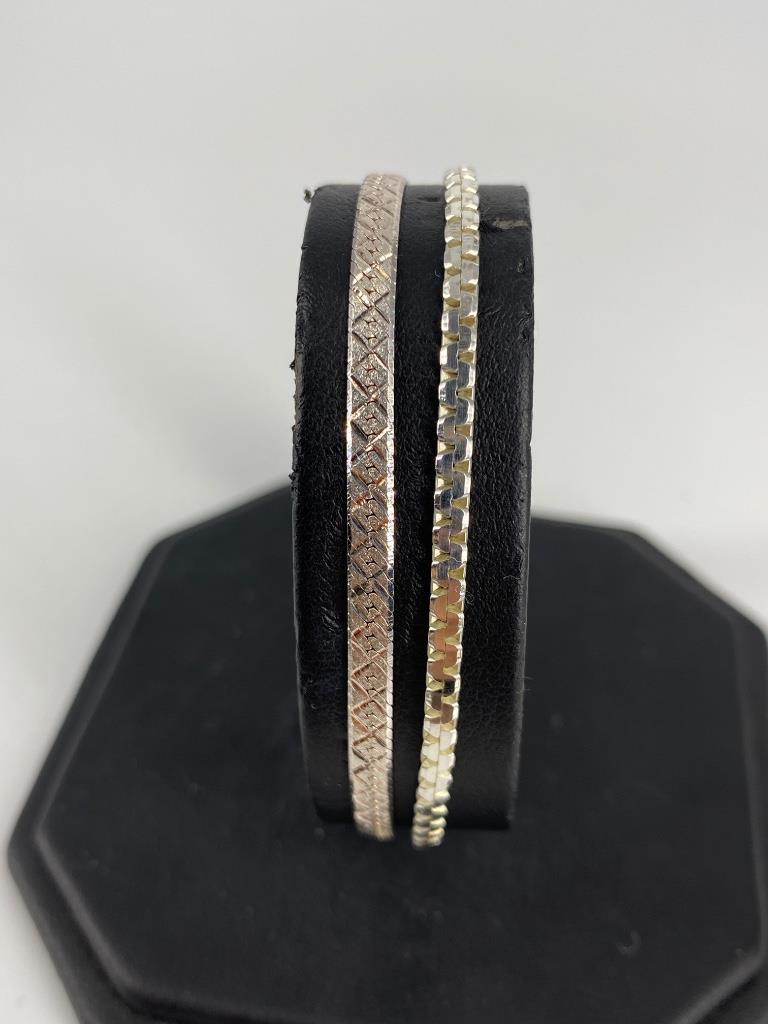 Two Sterling Silver Bracelets: Two Sterling Silver Bracelets Both Italian made including one 7.125” herring bone chain bracelet with etched quilted pattern and matte finish, 7” serpentine chain bracelet with polished fi