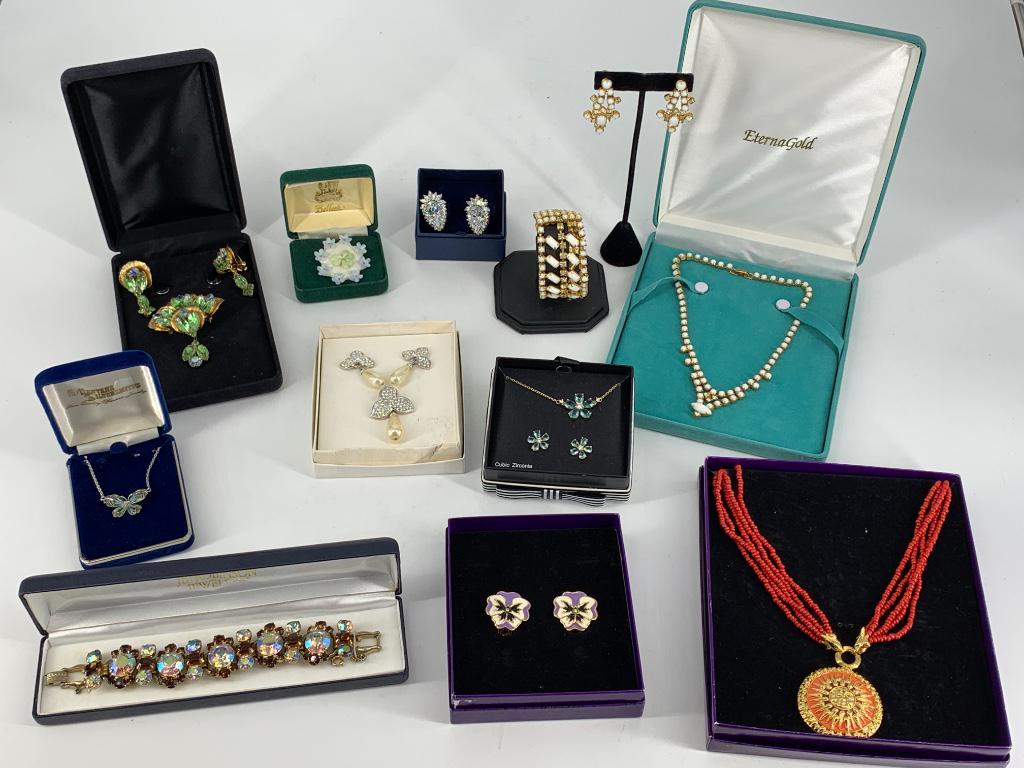 Box Lot of Fashion Jewelry: Box Lot of Fashion Jewelry Clear diamante stone cluster earrings (lever backs), CZ jewelry set with floral design ft. blue and clear CZ stones, vintage Belleek floral china pin (Irish made), silver to