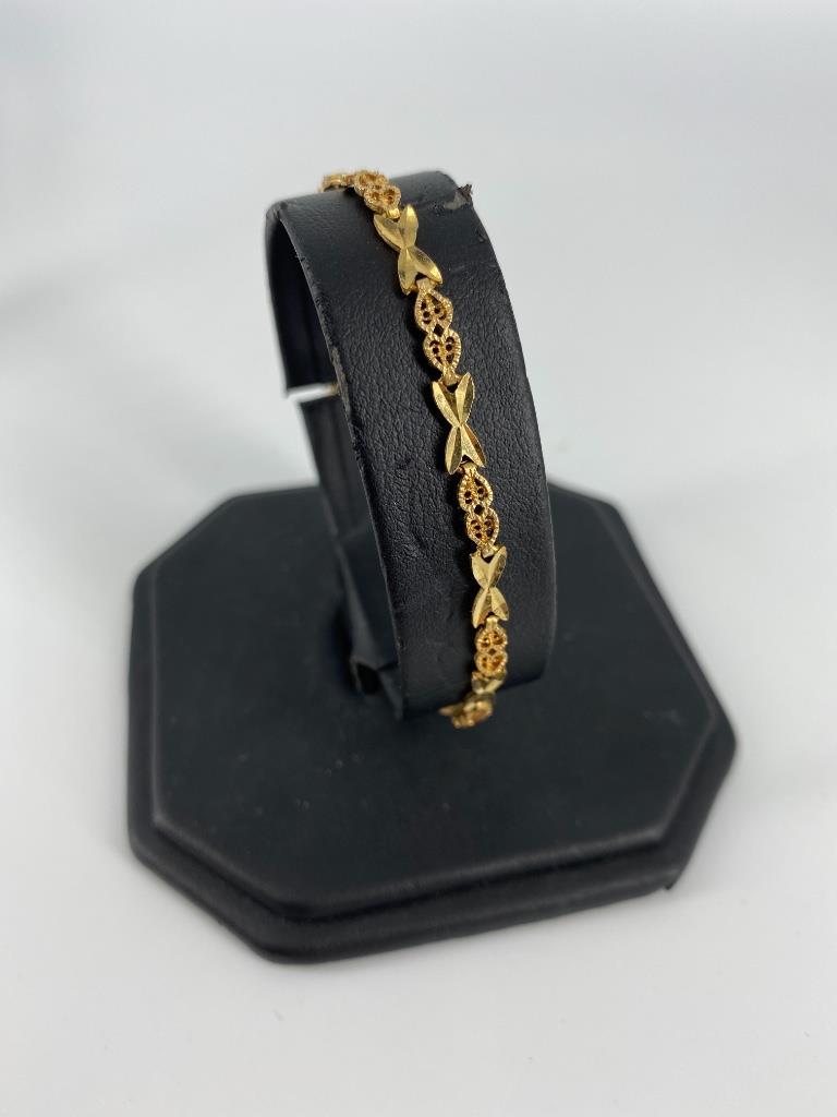14kt Yellow Gold Bracelet: 14kt Yellow Gold Bracelet 7” in length featuring an openwork romantic heart and elongated â€œX” motif, made by Beverly Hills Gold, stamped and tested with box clasp closure (4.06 grams