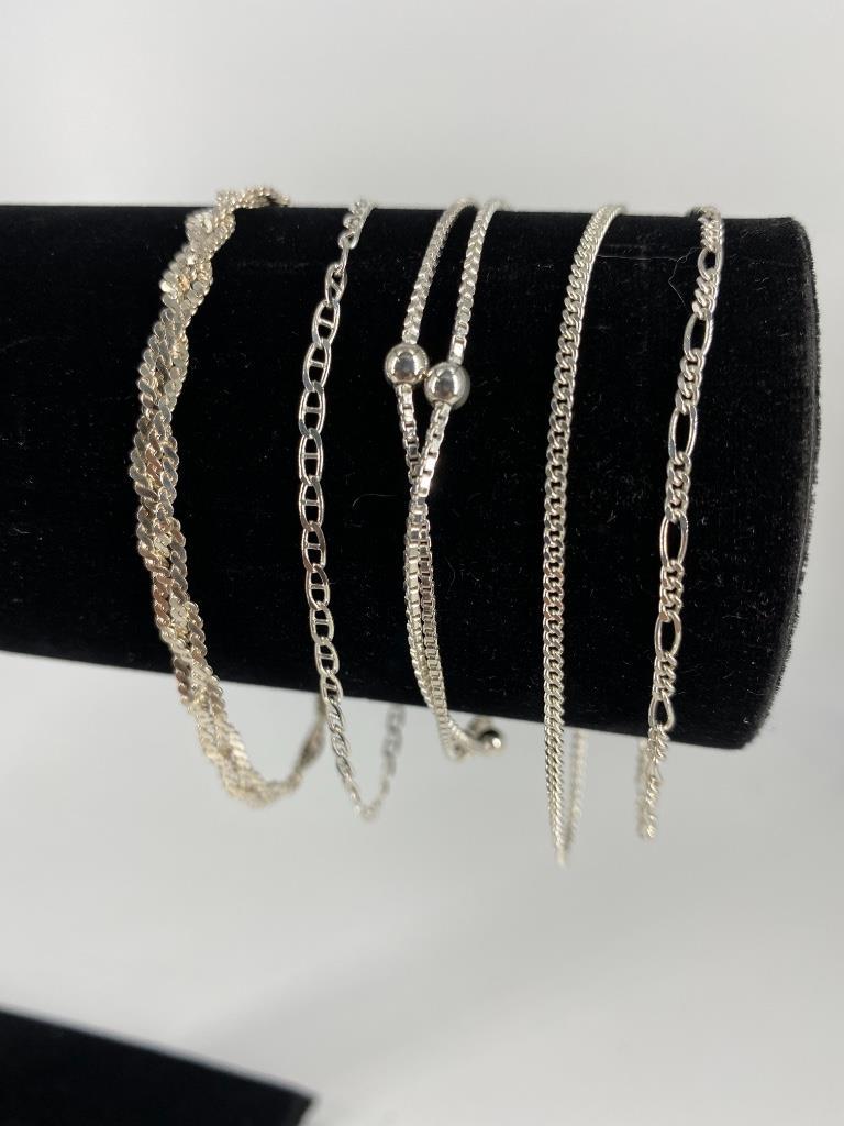 Sterling Silver Bracelets: Sterling Silver Bracelets Five in total, including 7” dual box chain strand bracelet with beaded accents, 7.25” braided serpentine chain bracelet, 7.5” anchor link bracelets 7.5&rdqu