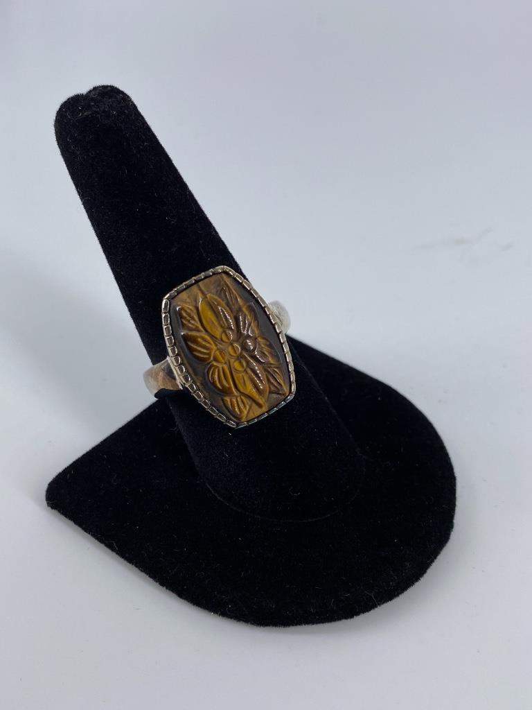 Sterling Silver & Carved Tigers Eye Ring: Sterling Silver & Carved Tigers Eye Ring Size 9, polished tapered shank ring with a bezel set tigers eye center stone featuring a hand carved floral motif. Stamped, tested & signed â€œWK” (0