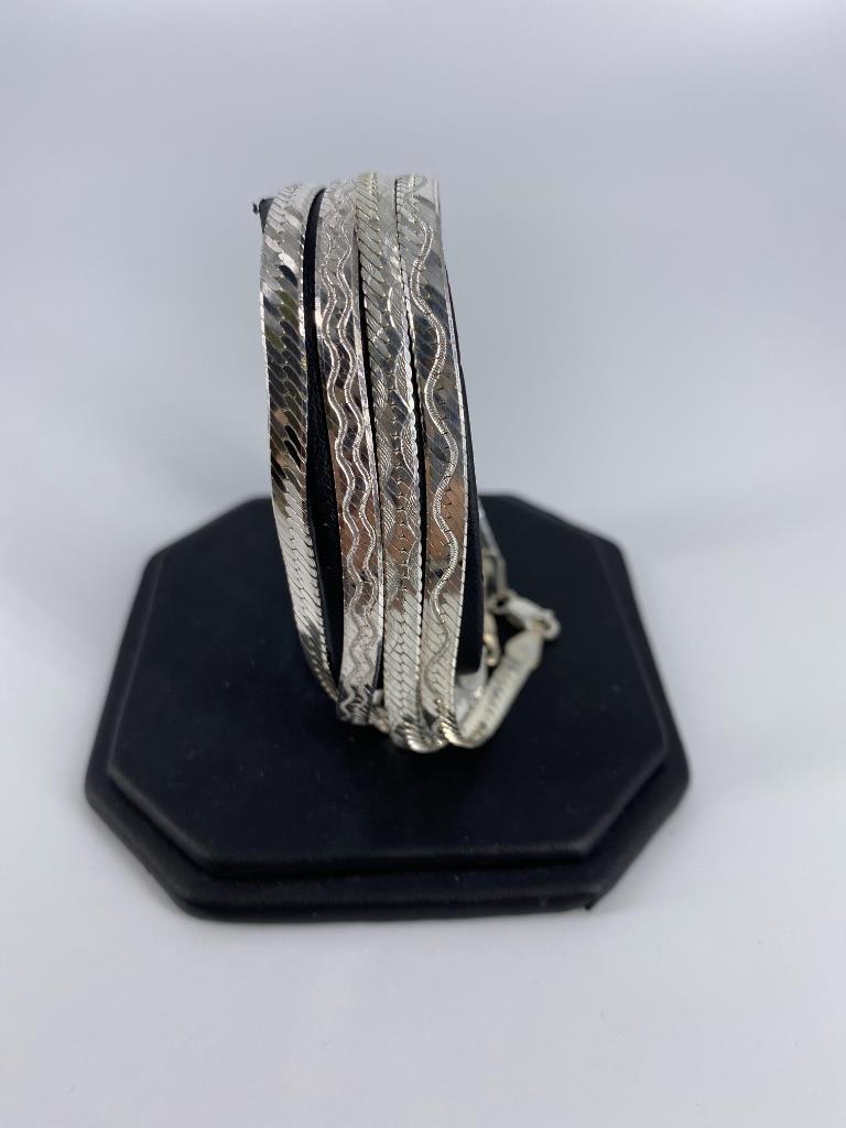 Sterling Silver Bracelets: Sterling Silver Bracelets Four Italian made herringbone chain bracelets (three with etched accents) and lobster clasp closure, each measuring approximately 7.5” in length with lobster clasp clos