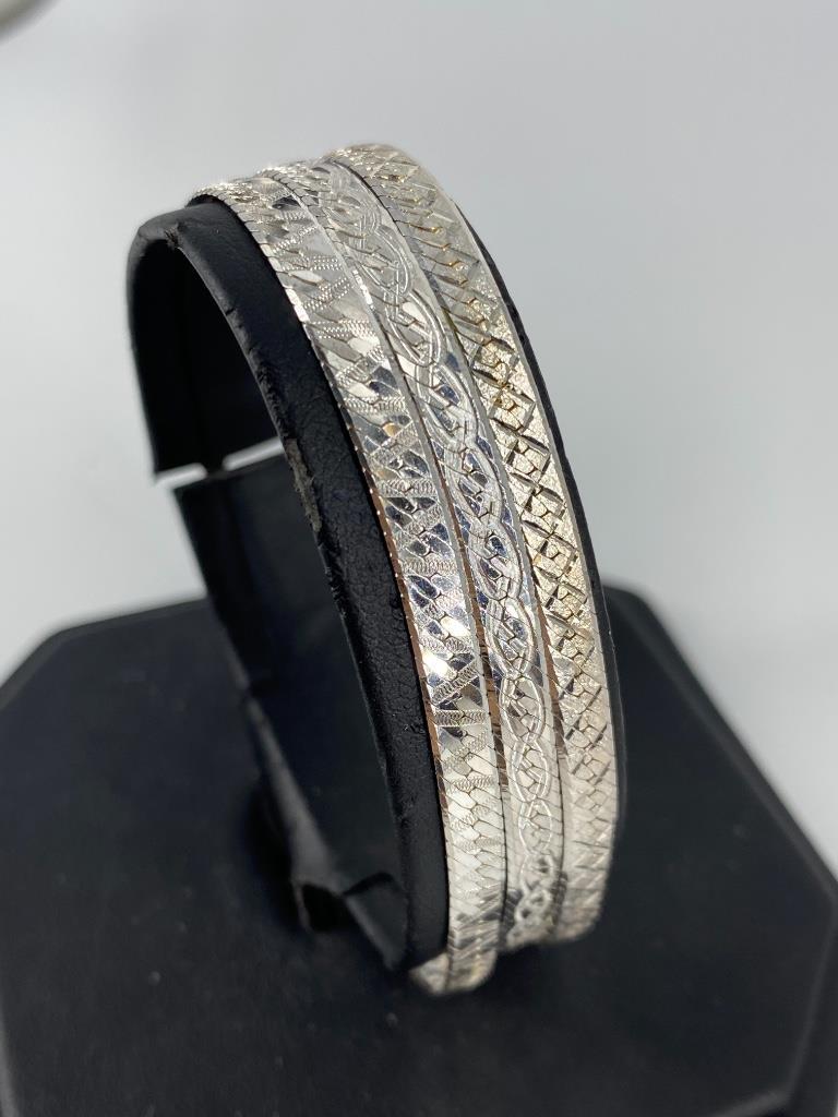 Sterling Silver Bracelets: Sterling Silver Bracelets Three herringbone chain bracelets with etched accents, all measuring approximately 7.75” in length, Italian made by Milor and feature lobster clasp closure, all stamped