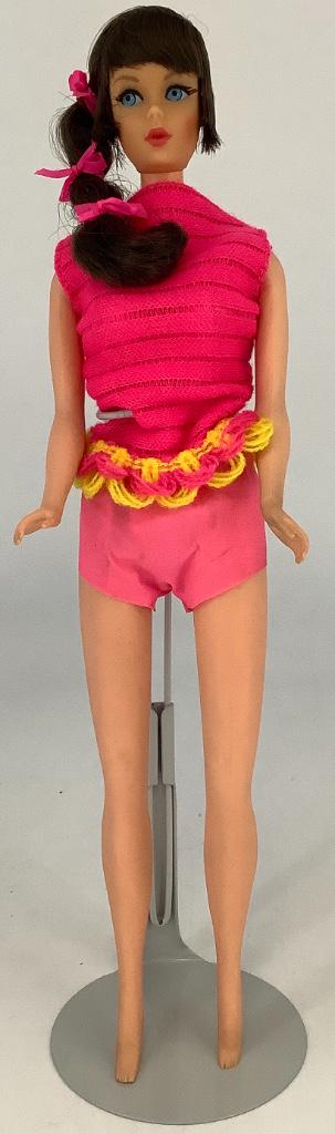 Brunette Talking Barbie. Doll wears original swim set: Brunette Talking Barbie. Doll wears original swim set with pink knit top and pink vinyl shorts, hair in original set with ribbons intact, facial paint is excellent, talking mechanism does not work, ri