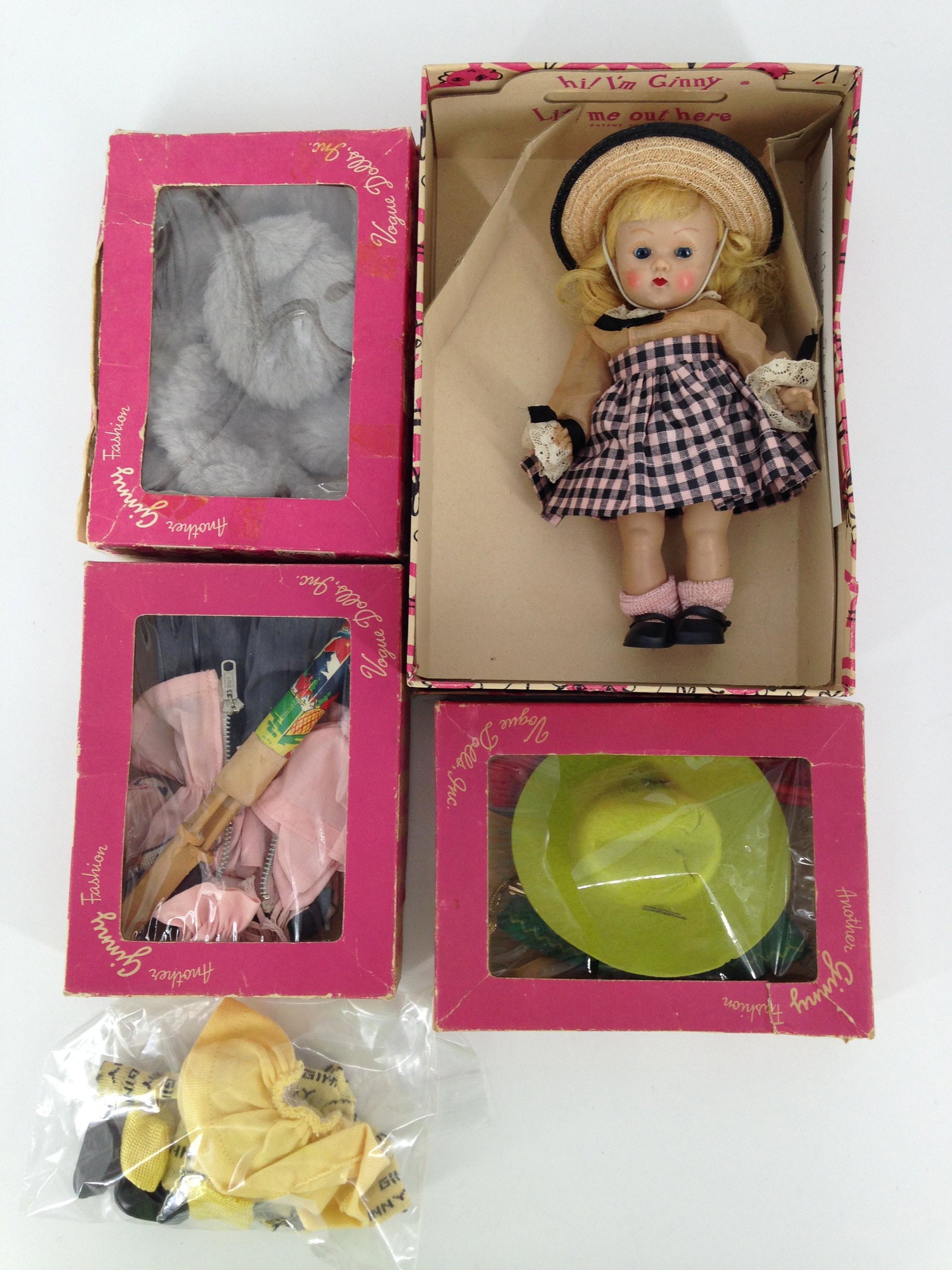 LOT VOGUE GINNY AND FOUR OUTFITS. INCLUDES 7" HARD: LOT VOGUE GINNY AND FOUR OUTFITS. INCLUDES 7" HARD PLASTIC SL GINNY IN BOX FROM THE 1953 "TINY MISS" SERIES, BLONDE MOHAIR WIG, BLUE SLEEP EYES, PAINTED LASHES, WEARS TAGGED "VOGUE" BERYL DRESS WITH U