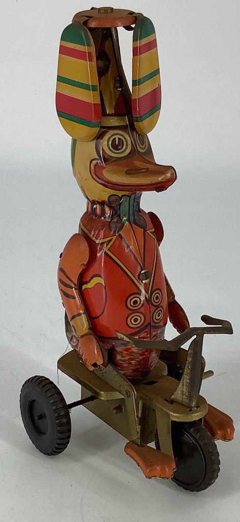 8” Tin wind-up toy on bike.: 8” Tin wind-up toy on bike.