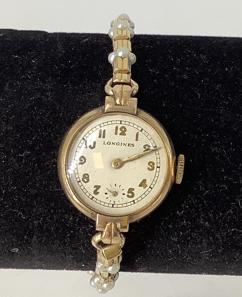 Vintage Ladies Wrist Watch: Vintage Ladies Wrist Watch 10KT gold filled ladies wrist watch from Longines, stretch band with faux seed pearl accents, 17 jewel movement, winds and sets at time of listing, in box