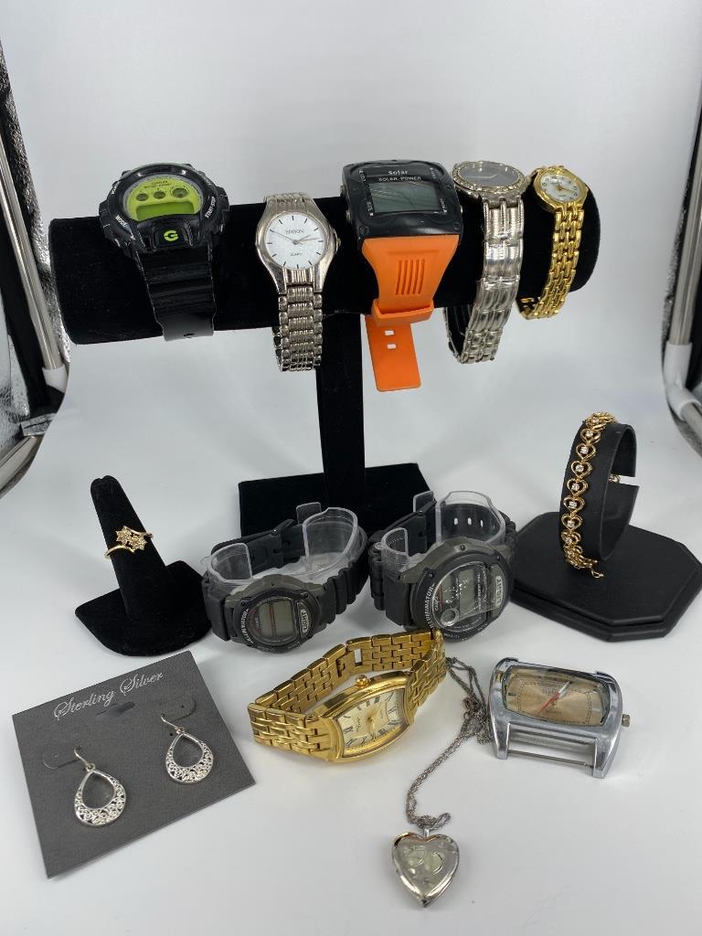 Box Lot Of Watches & Accessories: Box Lot Of Watches & Accessories Nine watches in total including a digital solar powered wrist watch with an orange band, Casio G-Shock wrist watch, silver tone Edison wrist watch with quartz movement