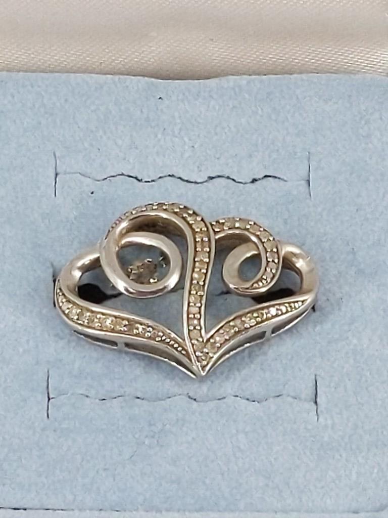 Sterling + Diamond Twin Hearts Pendant: Sterling + Diamond Twin Hearts Pendant Stamped and tested 925, 0.105 troy ounces total weight, signed with a star emblem, 25.6mm x 19.2mm in size, adorned with thirty-six (36) surface prong set melee 