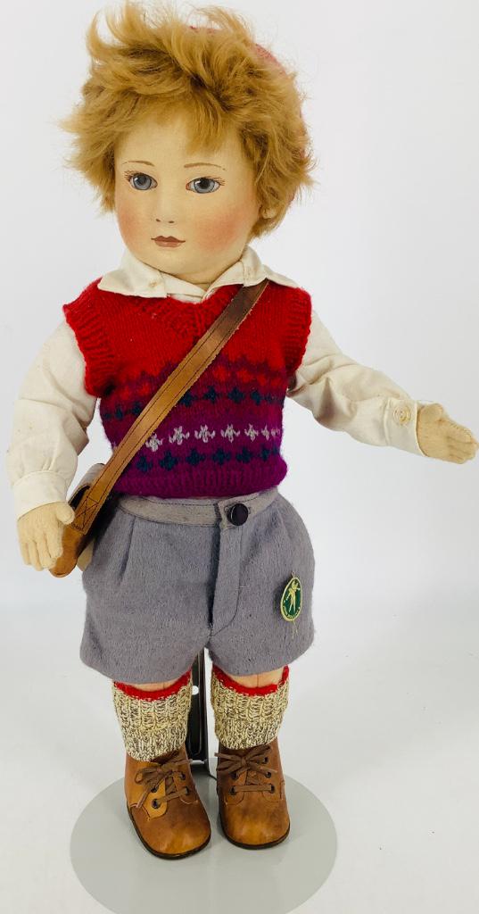 17" R. John Wright "Scott". All felt doll, disk jointed: 17" R. John Wright "Scott". All felt doll, disk jointed at the neck, shoulders and hips, mohair wig, molded and painted facial features, dressed in original clothing with leather shoes and satchel. Pa