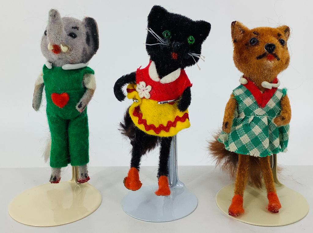 (3) Vintage flocked Wagner Kunstlerschutz West German: (3) Vintage flocked Wagner Kunstlerschutz West German dressed animals. Each is 3 1/2" tall with glass eyes. Includes a black cat, elephant and lady fox, all with real fur tails. The cat retains its la