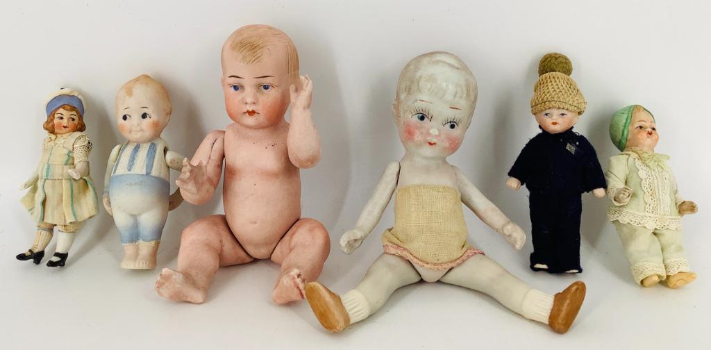 (6) small all bisque dolls with molded and painted hair: (6) small all bisque dolls with molded and painted hair and facial features - (3) with one-piece head and torso including 8½" Bruno Schmidt 425 character baby with jointed arms and legs, 4" Nip
