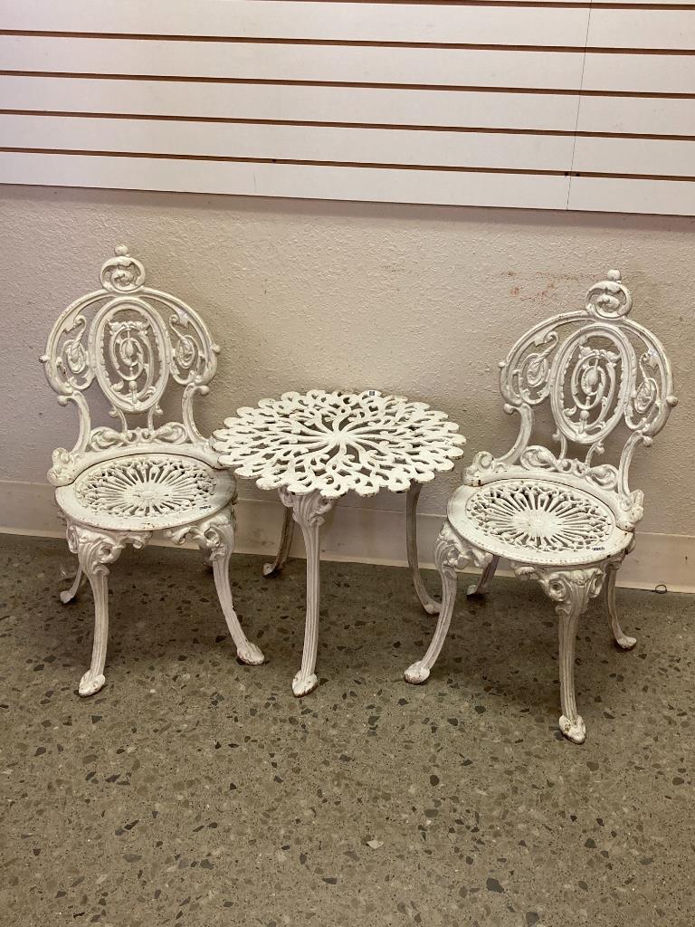 Cast iron table and two chairs, chairs are 31â€ high. (1 of 4)