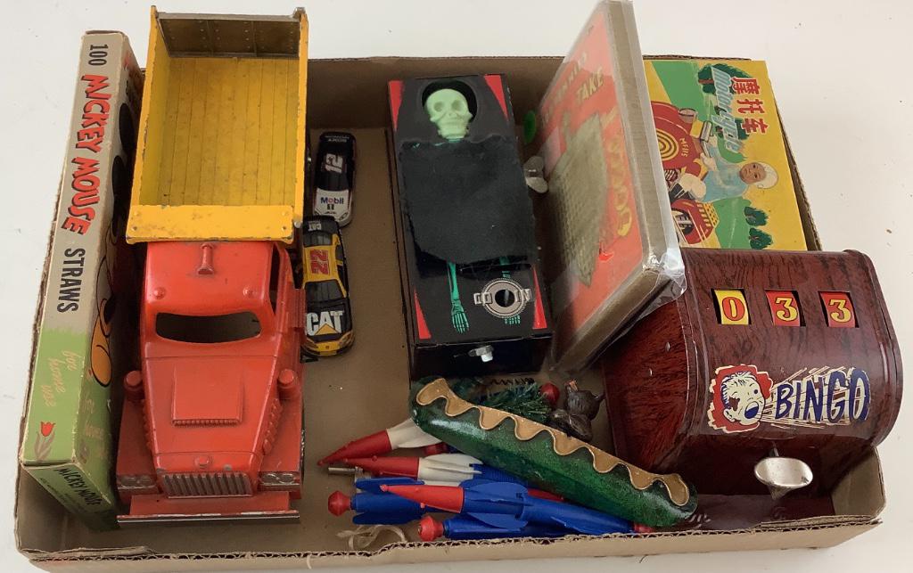 Metal dump truck 10” long. Bingo spinner. Motorcycle: Metal dump truck 10” long. Bingo spinner. Motorcycle that was made in China and a skeleton bank. 2 Hot wheels cars.